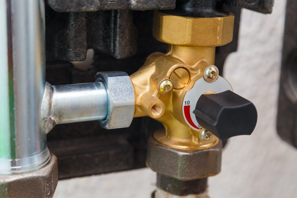Manual three way ball valve on pipe of industrial boiler heating system