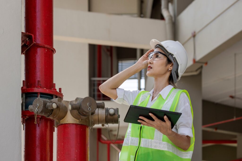 Technician engineer working in industrial plant by checking valve pipe