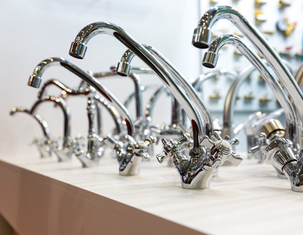 Kitchen faucets on shelf closeup, plumbing shop